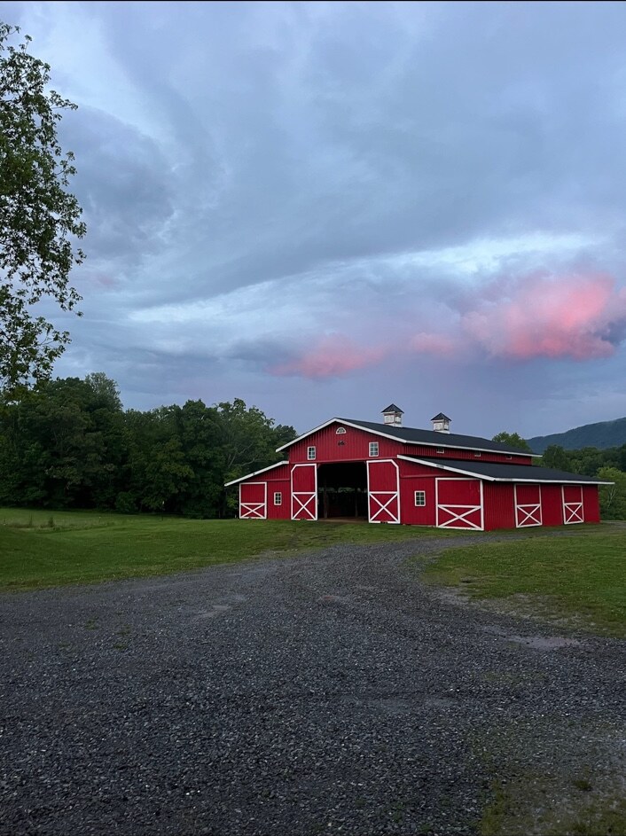Front view of the Sterling Hills barn beneath pink clouds